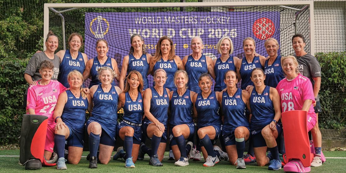 The Team USA Over-55 Field Hockey team poses for a team picture in front of a goal at the World Cup, including assistant coach Jess Weiss