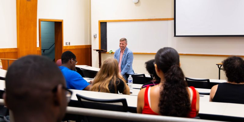President Michael Hill speaks with first-generation students in a Copley classroom
