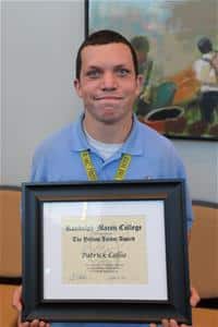 Patrick Collie, winner of a Yellow Jacket Award, holding his framed certificate.