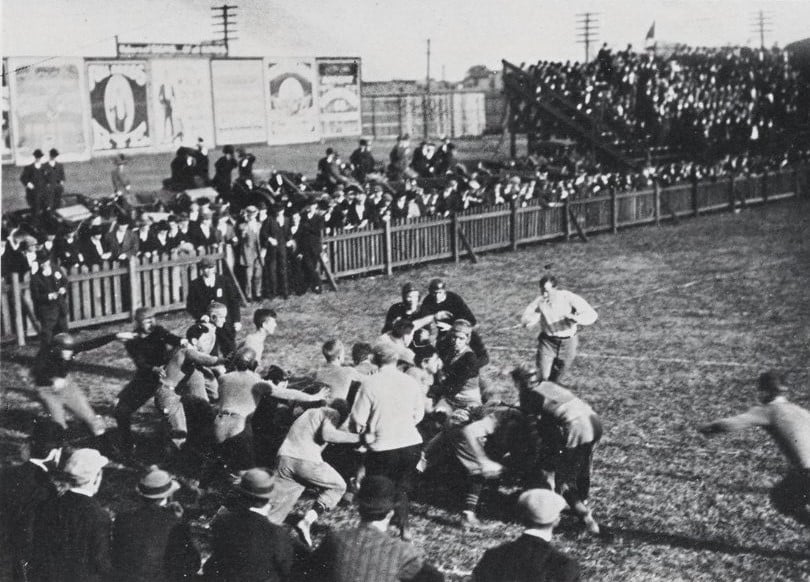 A black-and-white photo of an early match between R-MC's and Hampden-Sydney's football teams.