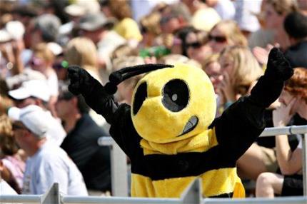 Buzz cheers on the football team with the crowd behind him