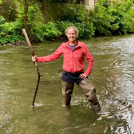 Stephanie Coster doing environmental DNA field work in a stream